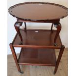 Mahogany oval coffee table with pie crust border on cabriole legs, and a oak two tier tea trolley (