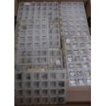 Ladies wristwatch movements in compartmentalized storage boxes, together with other watch movements