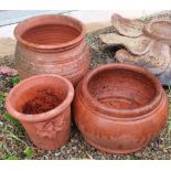 Three small terracotta planters (height 24cm)