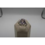 18ct white gold ring set with a pink tinted Burmese gem stone with diamond shoulders, 4.9g gross