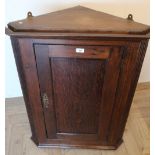 George III oak corner cupboard, crossbanded door and painted two shelf interior with reeded