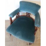 Edwardian walnut framed tub chair, upholstered in blue dralon, turned supports
