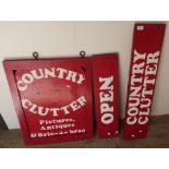 Three painted shop signs for "Country Clutter" (25 x 54cm) and an oak two tier tea trolley (4)
