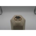 18ct gold ring set with 9 small diamonds, stamped 18ct, 2.1g