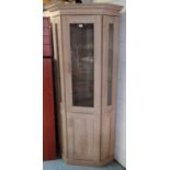 Light oak finish corner cabinet, with glazed upper and panelled lower doors (86cm x 195cm x 50cm)