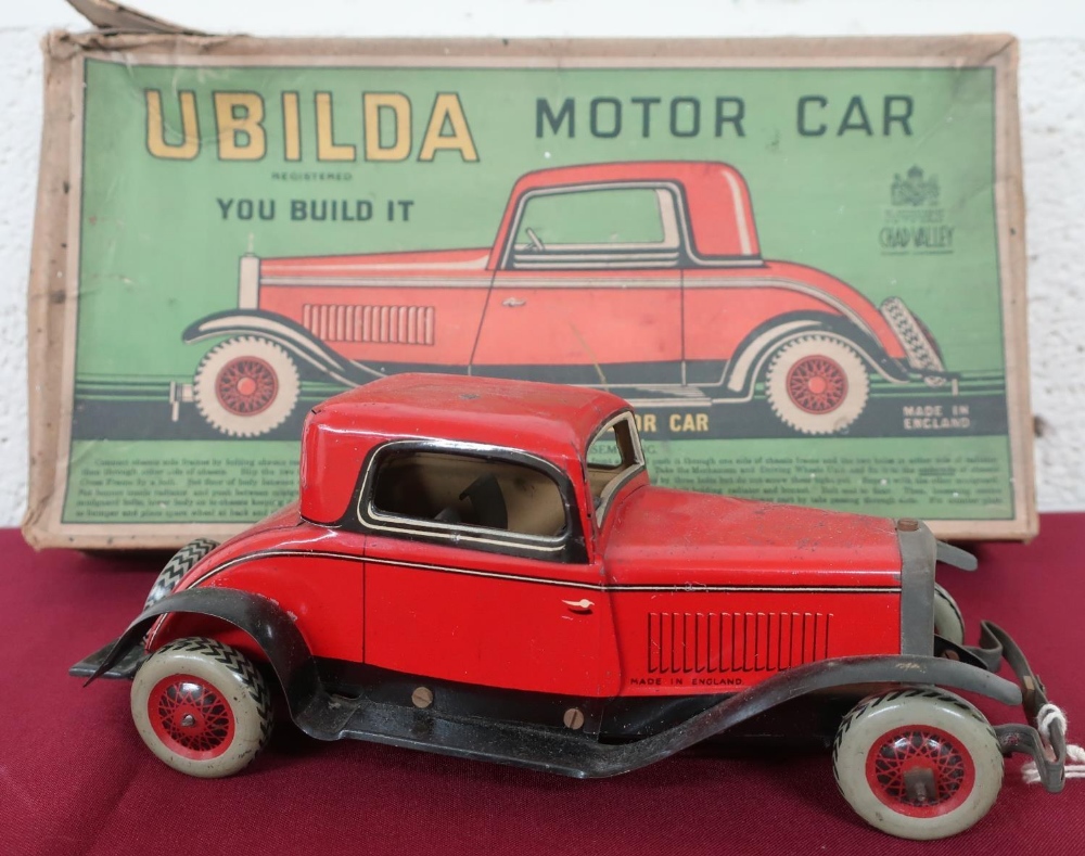 A Ubilda tin plate clockwork motorcar by Chad Valley (25cm), with spanner and two spare nuts and