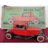 A Ubilda tin plate clockwork motorcar by Chad Valley (25cm), with spanner and two spare nuts and