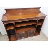 Edwardian walnut low bookcase, raised back and shelves above a pair of carved panel doors (137cm x