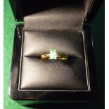 Boxed 18ct gold and rectangular baguette cut Brazilian emerald ring