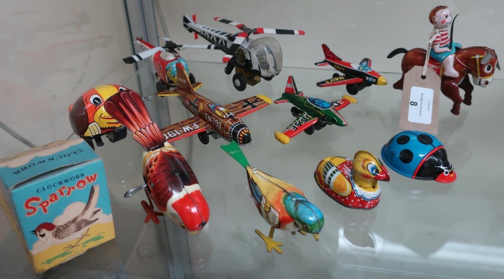 Friction powered tin plate aeroplanes and helicopters, a boxed clockwork sparrow, donkey boy and