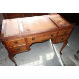 Queen Anne style walnut knee-hole writing desk with inset tooled leather top above five drawers,