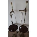 Pair of 20th C adjustable floor lamps with turned circular mahogany centre table, with turned