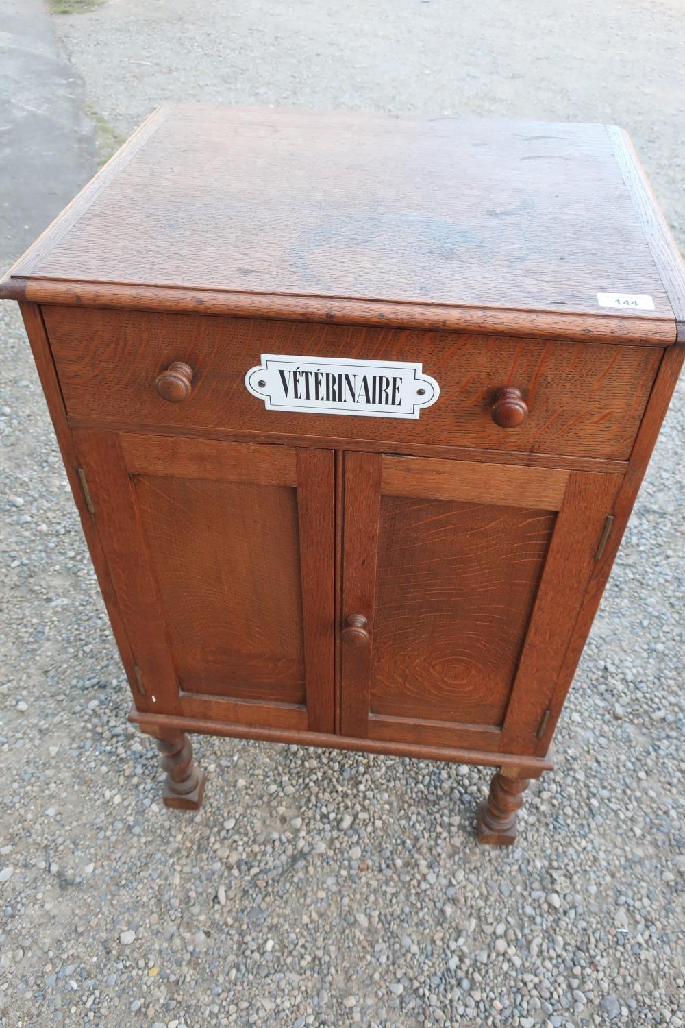 Early 20th C oak Veterinary cabinet with single drawer above two cupboard doors, on barley twist