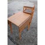 Melamine topped drop-leaf kitchen table and a set of four retro style beech framed stacking stools