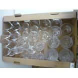 Box containing a selection of various assorted glassware including various champagne flutes, cut