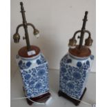 Pair of blue & white Chinese table lamps, square tapering bodies on hard wood stands, with double