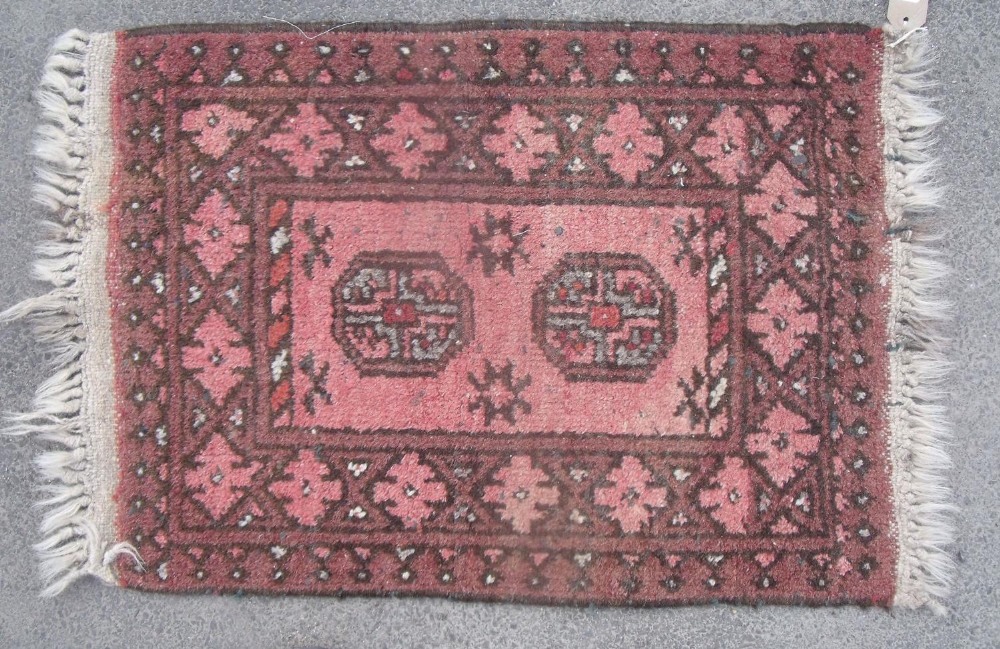 Traditional pattern Islamic prayer rug, brick red ground with two central medallions and geometric