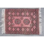 Traditional pattern Islamic prayer rug, brick red ground with two central medallions and geometric