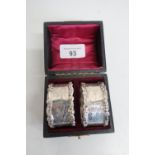 Pair of Edwardian hallmarked silver oval napkin rings, with cast borders and engraved detail,