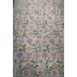 Beige ground wool-work rug with floral pattern (178cm x 275cm)