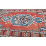 Red and blue ground woollen rug (220cm x 325cm)