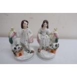 Pair of Staffordshire figures of a Scotsman and his lass with game birds and rabbits