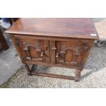 Old Charm style side cabinet with two panelled cupboard doors and turned legs on trestle base