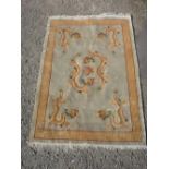 Chinese embossed washed woollen rug, green ground set with Chinese dragons chasing a flaming