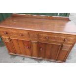 Old Charm style oak sideboard with two single frieze drawers (one part fitted), above two cupboard