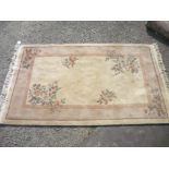 Chinese embossed washed woollen rug, beige ground, decorated with flowers (263cm x 157cm)