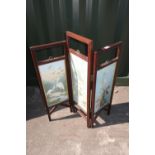 Edwardian oak framed two fold firescreen, the three rectangular panels painted with storks and