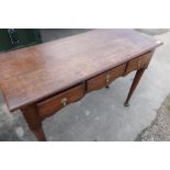 Early 19th C oak side table with three frieze drawers, shaped apron on turned tapering legs with pad