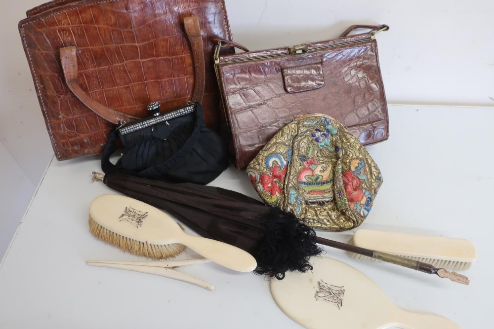 Two crocodile skin handbags, a parasol, a needlework covered bag with enamel clasp etc (one box)