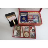 Red leather jewellery box containing a quantity of costume jewellery including Acurist watch,