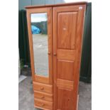 Pine combination wardrobe with full length panelled door with offset mirrored door and three drawers