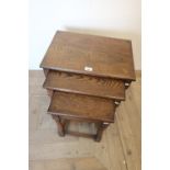 Oak nest of three rectangular occasional tables on turned supports joined by stretchers