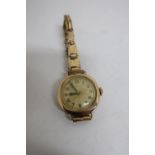 9ct gold hallmarked ladies wristwatch, with Isis movement on gold plated strap, and four 9ct gold