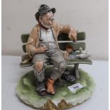 Naples Capodimonte style model of a tramp feeding pigeons on a bench, by B. Merli