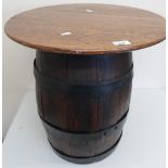 Small oak coopered barrel stool with hinged lift up circular top, wrought metal strap work and