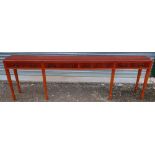 Modern yew wood style four drawer narrow serving table (243cm x 33cm x 76cm)