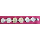 Indian silver bracelet of six miniature oval ivory panels, each painted with studies of exotic