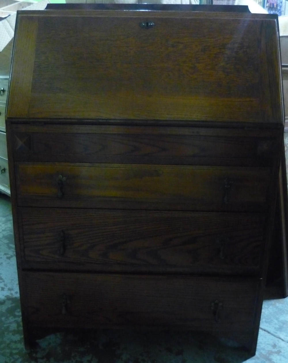 20th C oak bureau, slope fall front above concealed drawer, three further drawers below, on