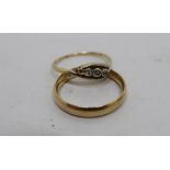 18ct gold hallmarked wedding band and a hallmarked three stone diamond ring (2) 5.5 grams