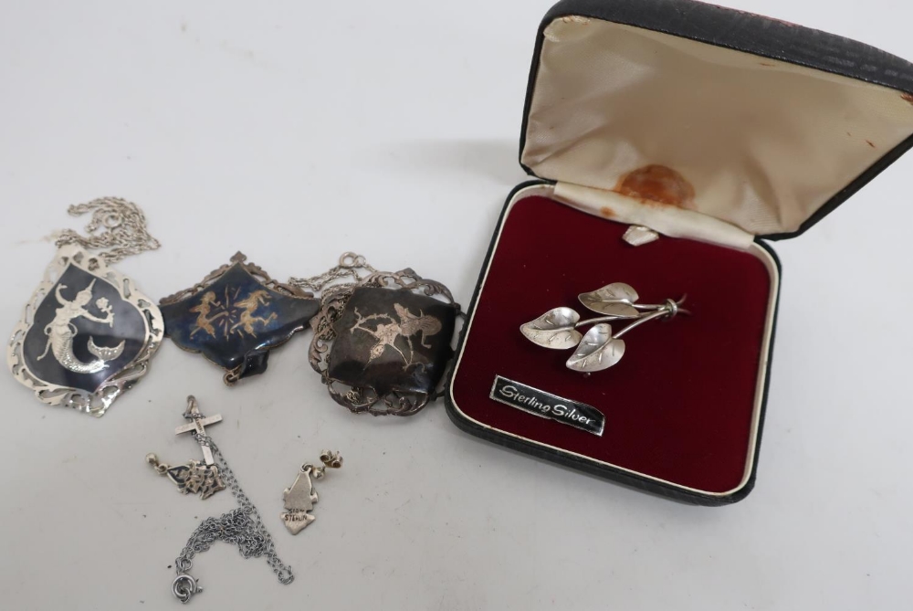 Two Siam sterling silver brooches, a pendant and pair of earrings, a sterling silver crucifix and