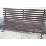 20th C garden bench seat with wooden slats, on curved wrought metal supports (162cm x 82cm x 77cm)
