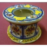 Spanish majolica capstan shaped inkwell decorated with flowers, (10cm x 6cm)