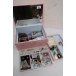 Pink jewellery box with mirror lid and two lift out trays containing a large quantity of costume