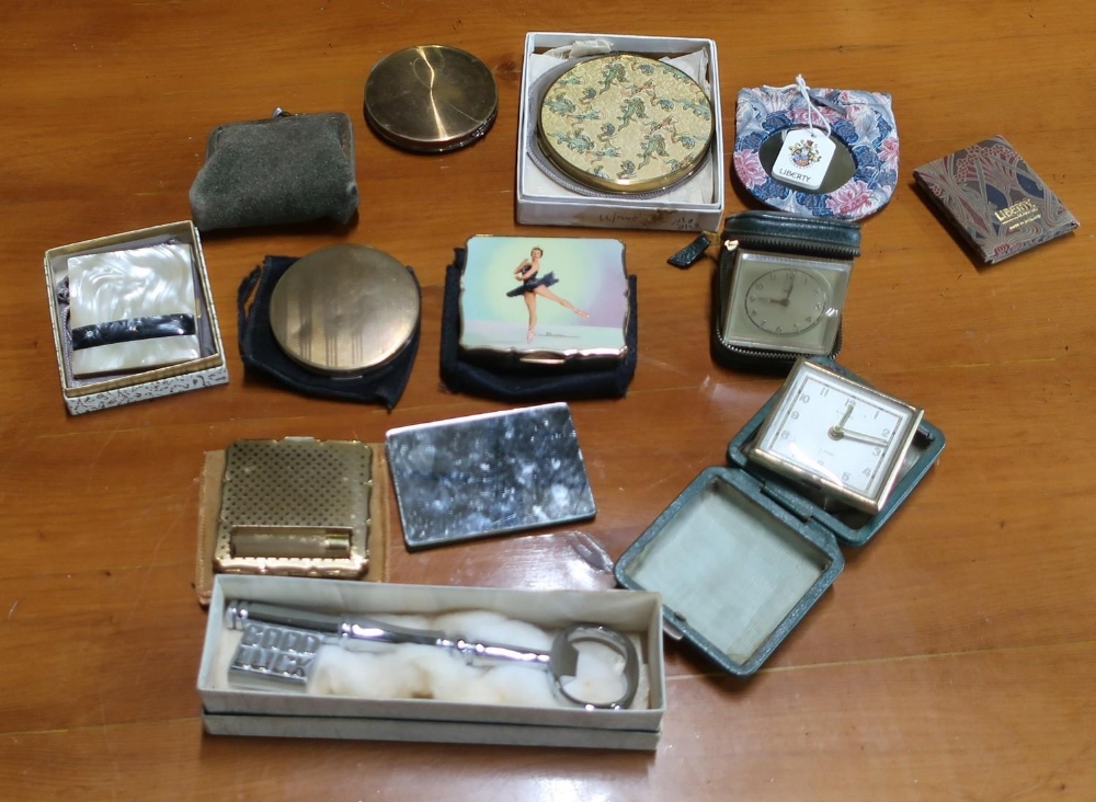 Six musical and other vintage powder compacts, three travelling clocks, a Good Luck key, Liberty