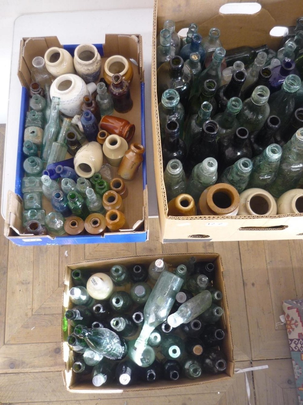 Collection of bottles, including green cods etc, clay bottles, ink wells etc (three boxes)