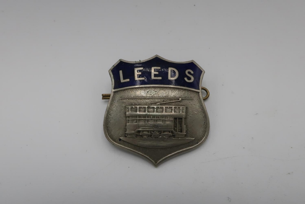 White metal and blue enamel Leeds Tram shield shaped cap badge, by Firmin London